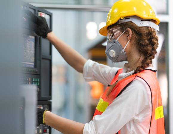 engineer using industrial computer in factory